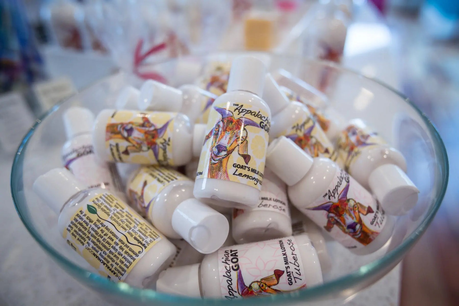 Small bottles of Appalachian Goat's Milk Lotion in Lemongrass and Tuberose scents.