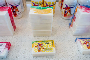 Lemongrass goat's milk soap slices with colorful swirls.