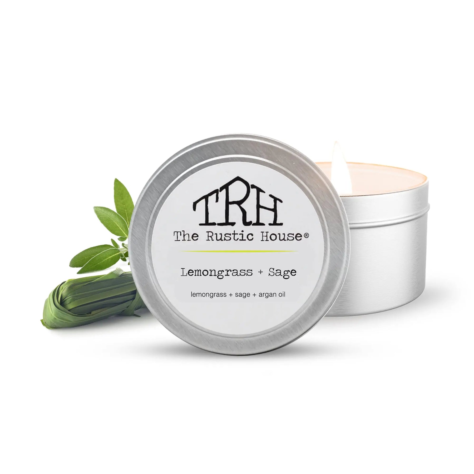 Lemongrass Sage travel tin candle from The Rustic House with lit wick.