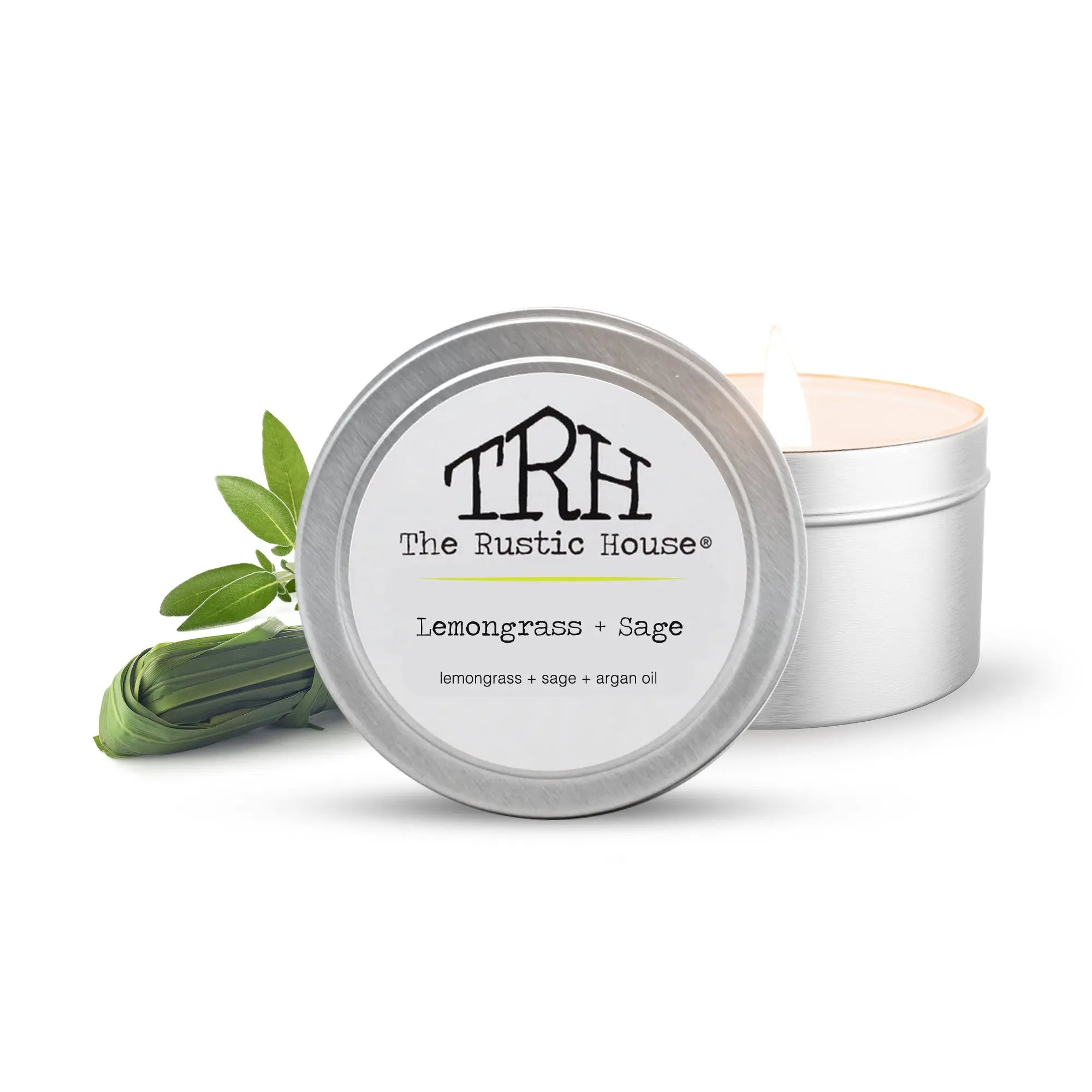 Lemongrass Sage travel tin candle from The Rustic House with lit wick.