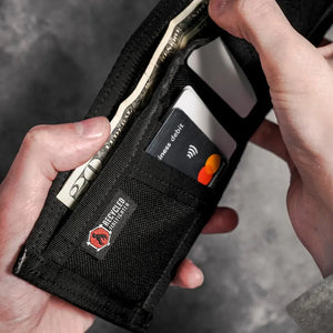Black wallet holding US dollar bills and a debit card.