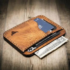 Brown leather minimalist wallet with credit cards, a business card, and a dollar bill.