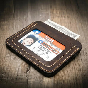 Brown leather minimalist wallet with Texas driver's license and cash.