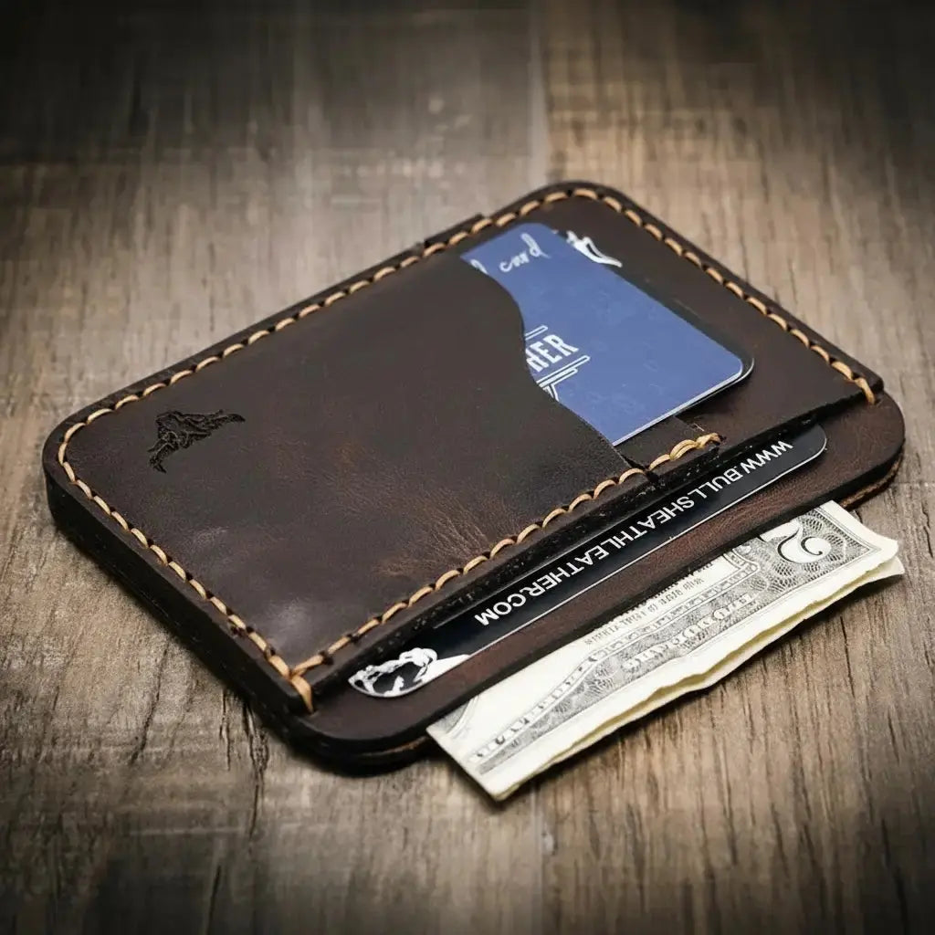 Brown leather minimalist wallet with card and US dollar bill.