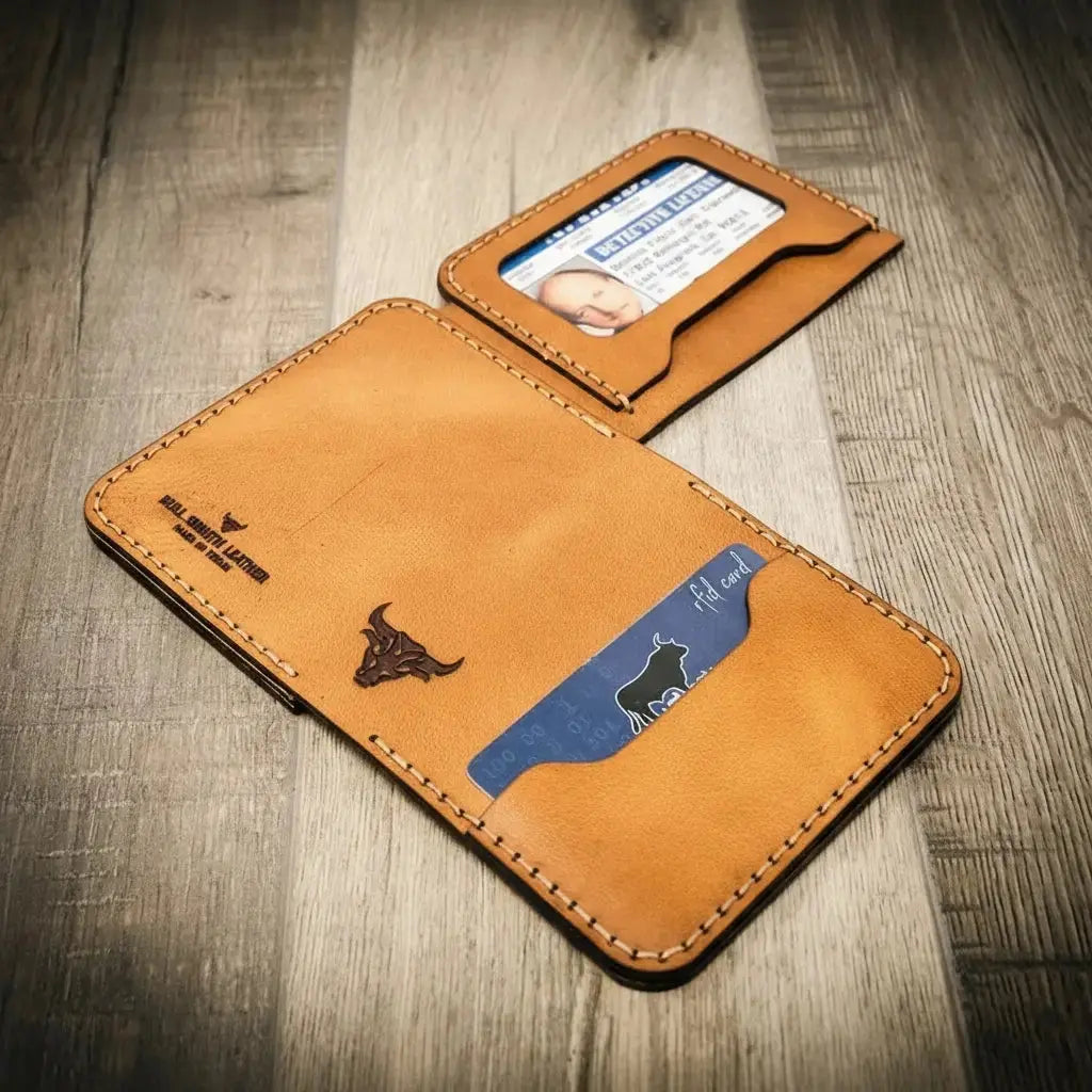 Tan leather minimalist badge wallet with ID window and card slots, featuring a bull logo.