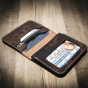 Brown leather bi-fold wallet with ID window showing a detective license and card slots.