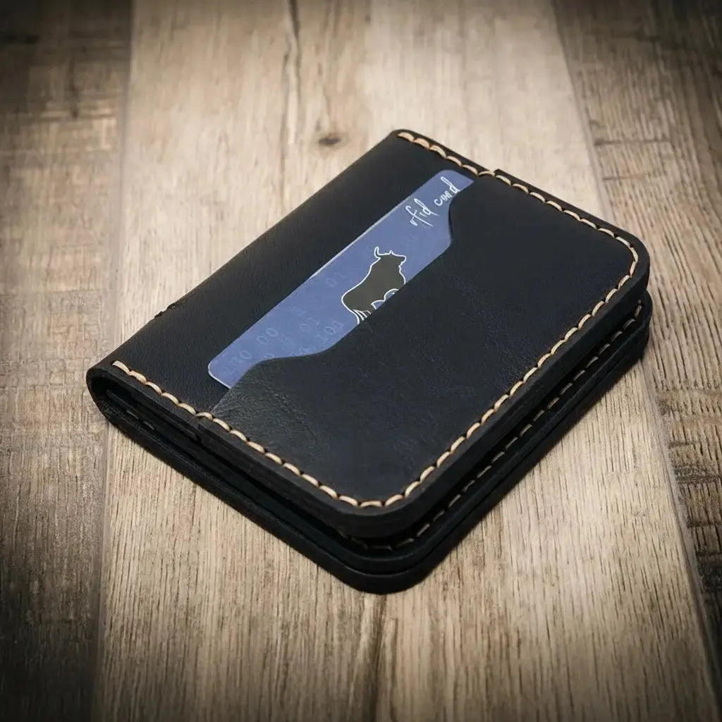 Black leather minimalist badge wallet with a card showing a bull logo.
