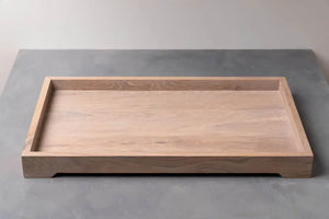 Wooden tray: A rectangular light-colored wood tray with a raised border is on a gray surface.