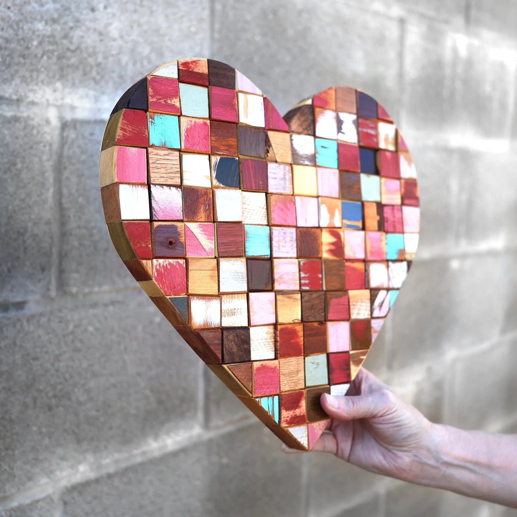 Mosaic heart art made of colorful reclaimed wood blocks
