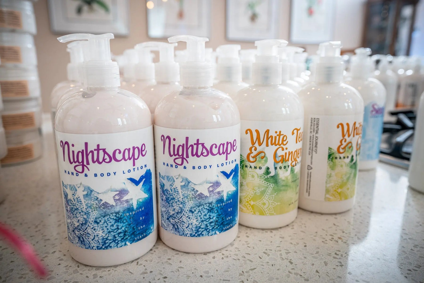 Nightscape Hand & Body Lotion bottles and White Tea & Ginger lotion by Essential Journeys.