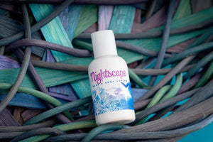 Nightscape Hand & Body Lotion bottle in 2 oz or 16 oz size, resting in a woven basket.