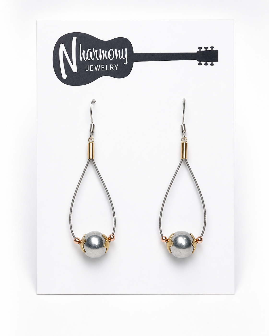 Teardrop-shaped earrings with pearls on a 'N Harmony Jewelry' card.