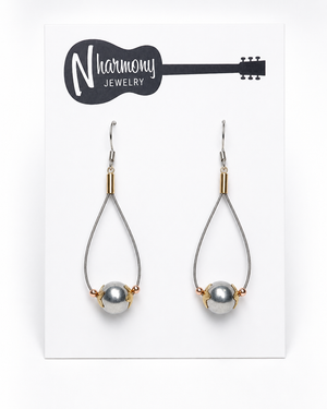 Teardrop-shaped earrings with pearls on a 'N Harmony Jewelry' card.