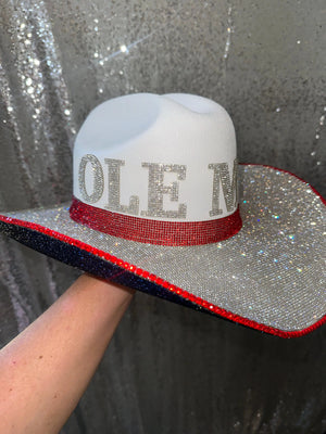 White cowboy hat with "OLE MISS" spelled out in rhinestones and red and blue trim.