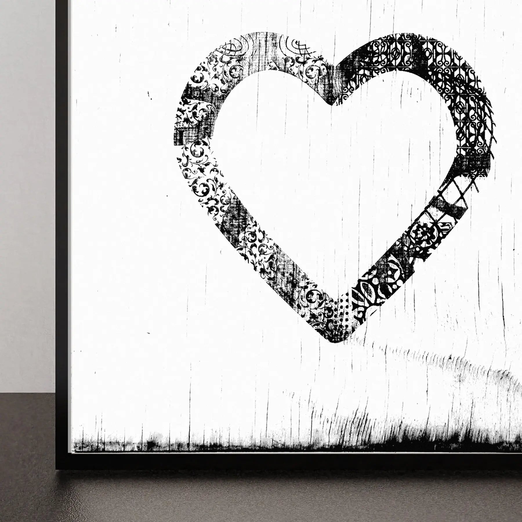 Black and white ornate heart art print with distressed wood background.