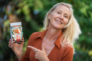 Woman holding Pomegranate Sunrise Arnica bath salts product