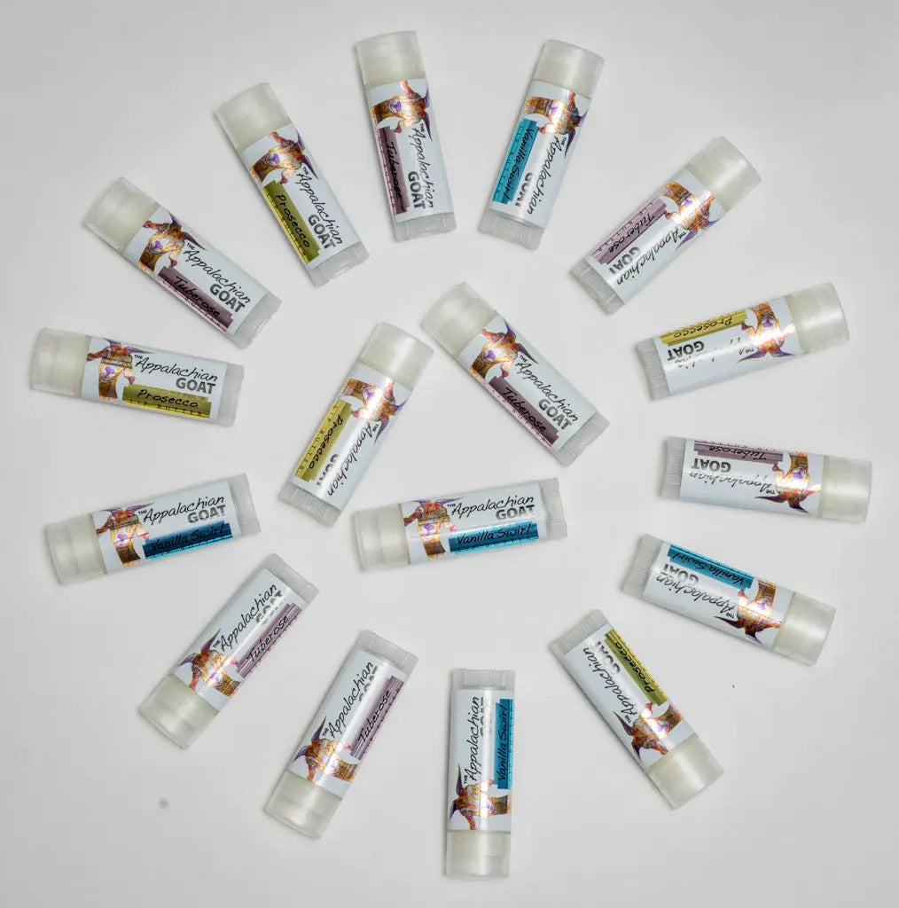 Multiple lip balm tubes with labels indicating flavors like Prosecco and Vanilla Swirl.