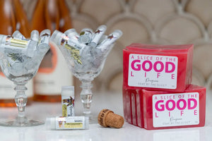 Prosecco soap slices and lip balms displayed with ice in crystal glasses by Essential Journeys.
