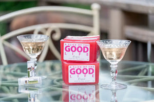 Two pink Prosecco scented soap bars with lip balms and champagne glasses.