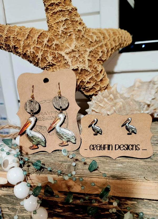 Pelican Earrings: handpainted wooden earrings with a starfish and shell backdrop from Main Street Collective store.