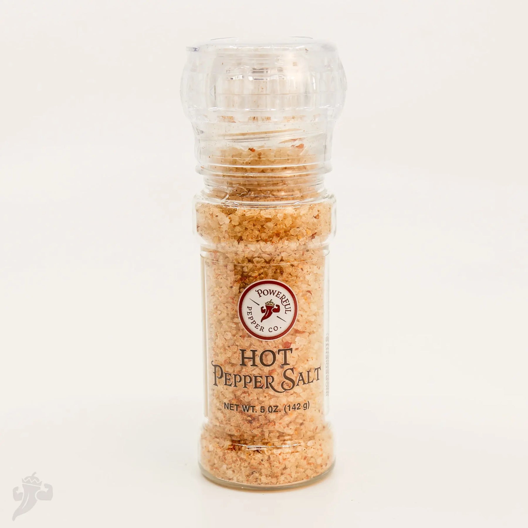 Clear plastic grinder filled with coarse hot pepper salt