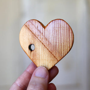 Wooden heart made from reclaimed wood with a hole.