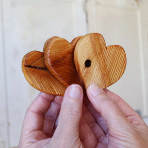 Wooden heart ornaments made from reclaimed piano soundboards.