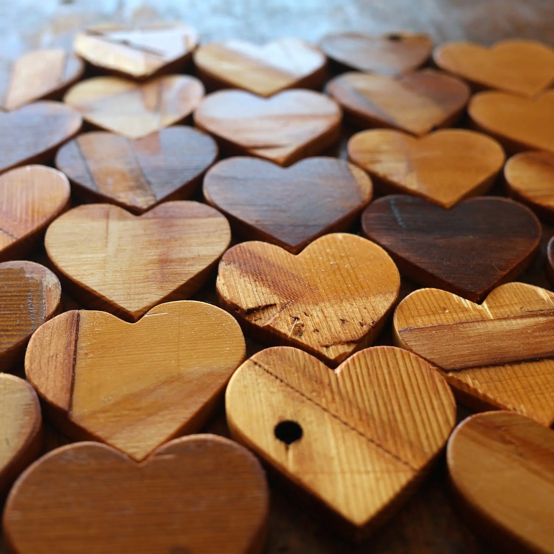 Piano hearts made of wood arranged closely together.