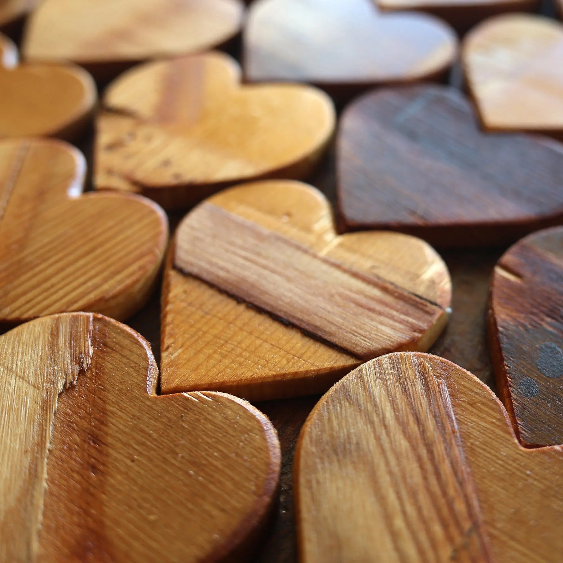 Wooden heart shapes made from reclaimed piano soundboards.