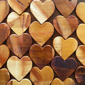 Wooden hearts with natural wood grain in a close-up pattern.