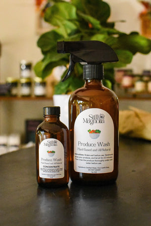 Still Magnolia plant-based produce wash concentrate and spray bottle.