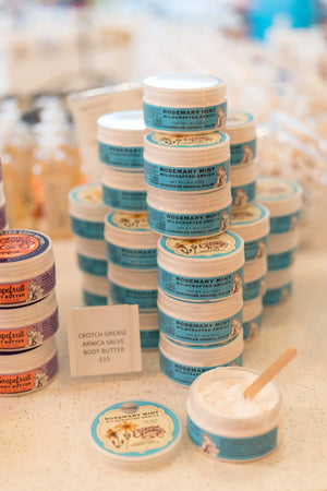 Stacked jars of Rosemary Mint Wildcrafted Arnica Salve and Grapefruit Body Butter.