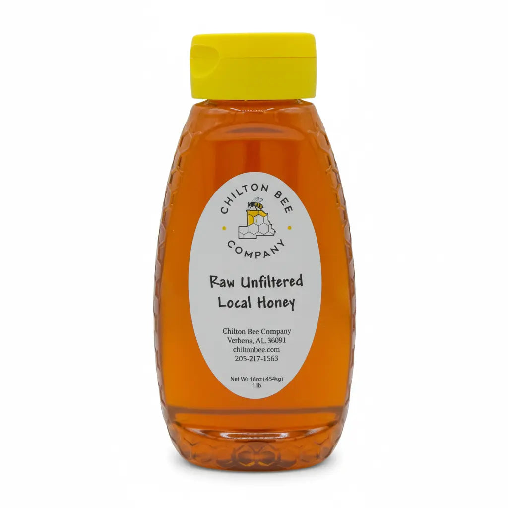Bottle of Chilton Bee Company Raw Unfiltered Local Honey with a yellow lid on a white background.
