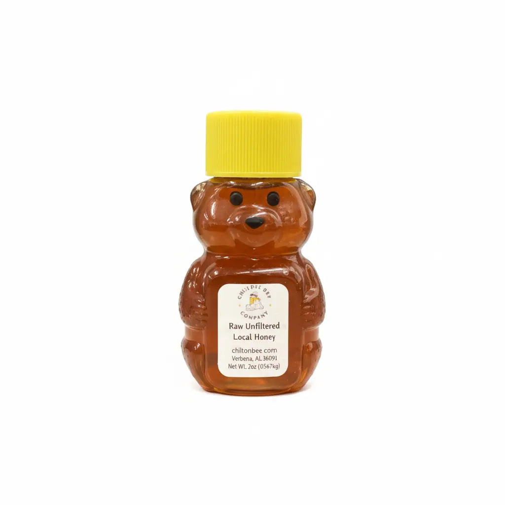 Honey bear bottle filled with raw unfiltered local honey with yellow lid and label.