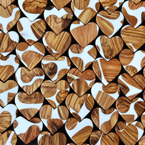 Heart-shaped objects with wood grain and white resin patterns.