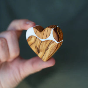 Handmade olive wood and white resin heart object.