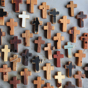 Collection of rustic wooden pocket crosses with varied natural wood grains and finishes.