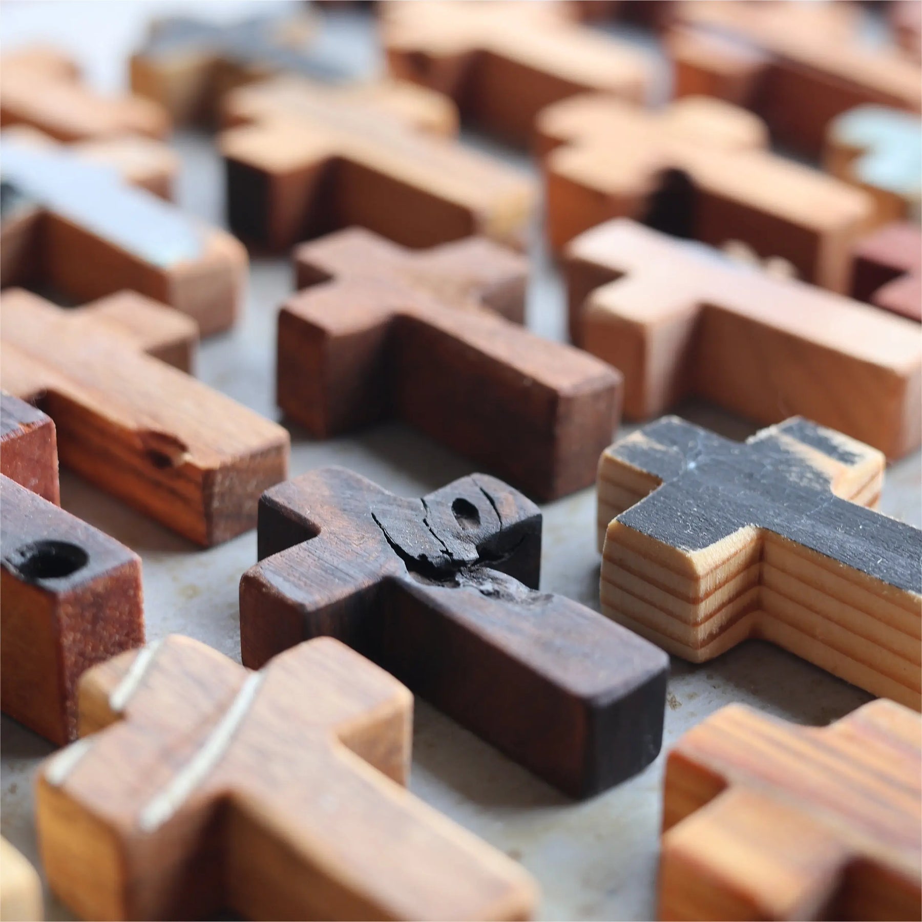 Close-up of varied wooden pocket crosses