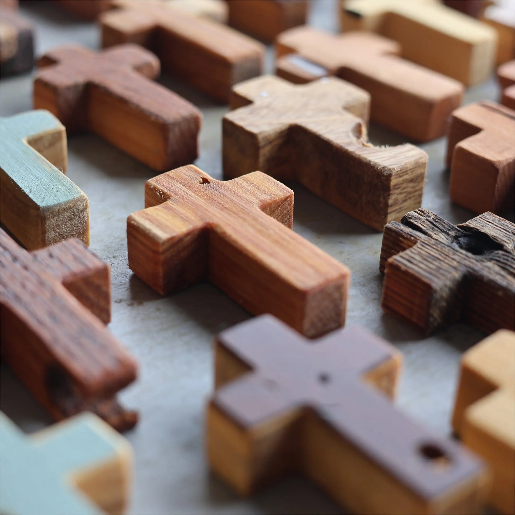 Collection of wooden pocket crosses with varied textures and colors