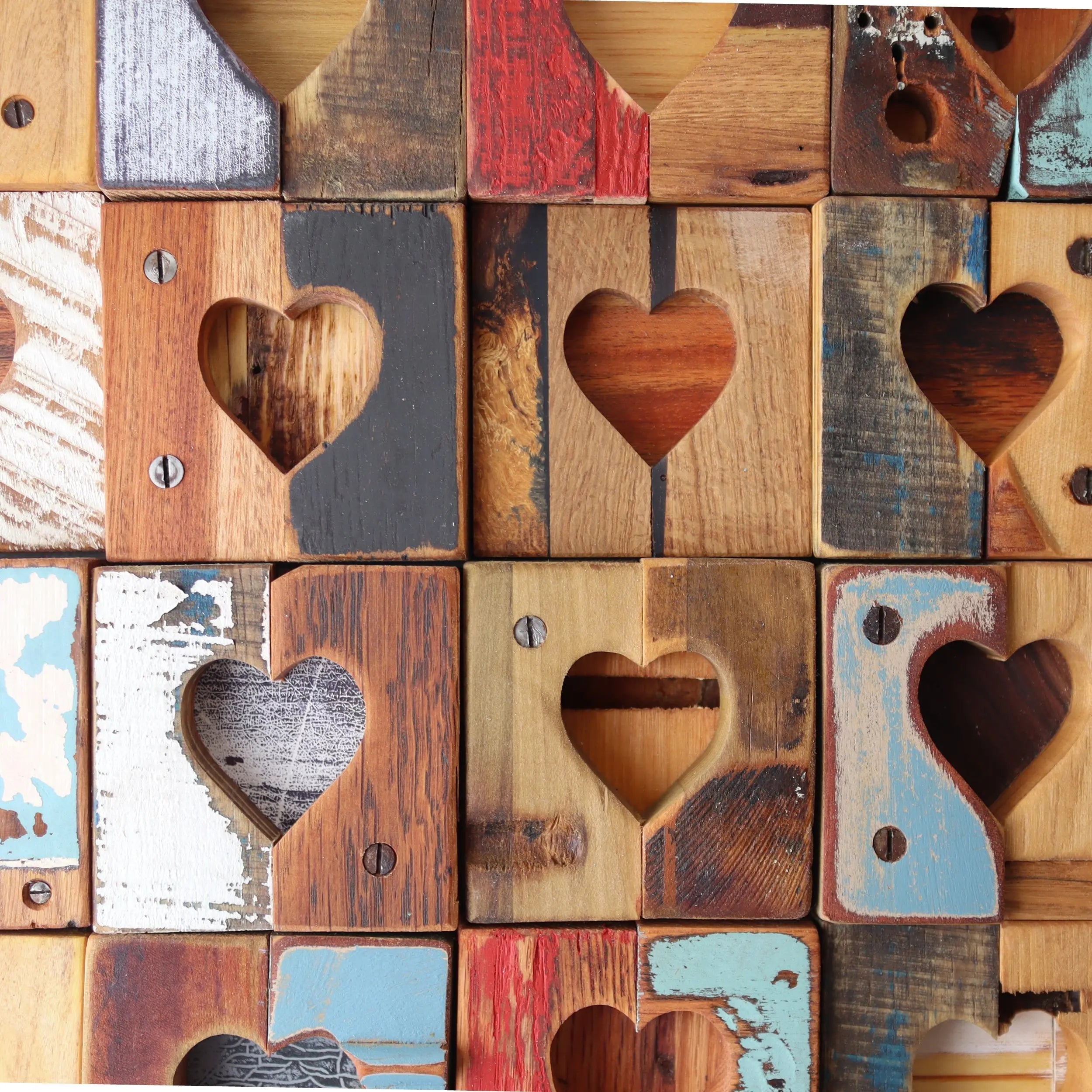 Rustic reclaimed wood tiles with carved heart shapes arranged in a grid.
