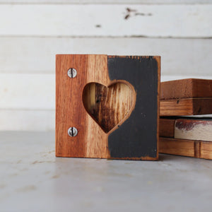 Rustic wooden tile with heart cutout, two-toned wood, and screws