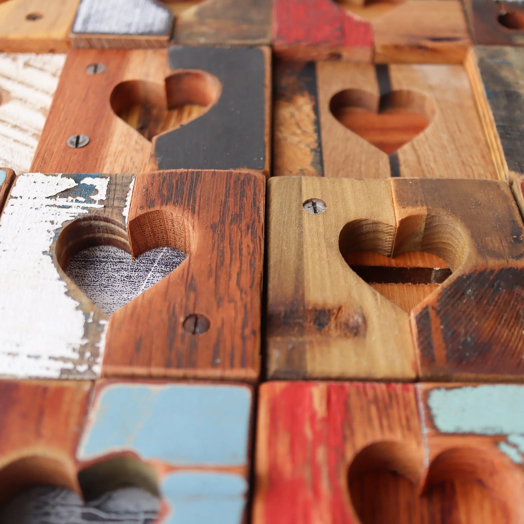 Rustic reclaimed wood tiles featuring carved heart shapes.