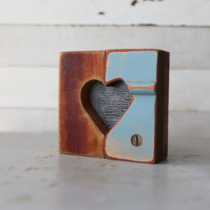Rustic wooden heart halves with visible grain and distressed paint.