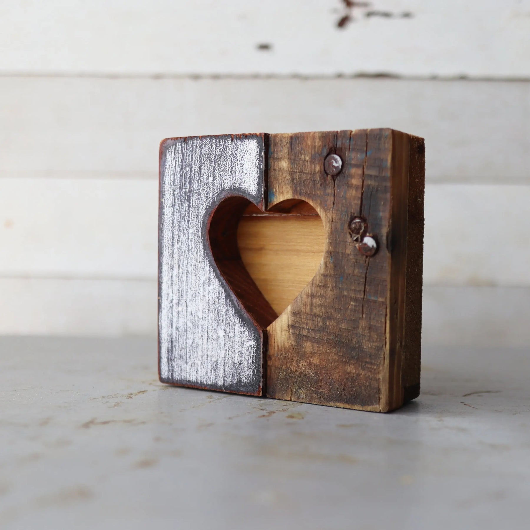 Wooden heart cut-out made of reclaimed wood with white distressed and natural finishes.
