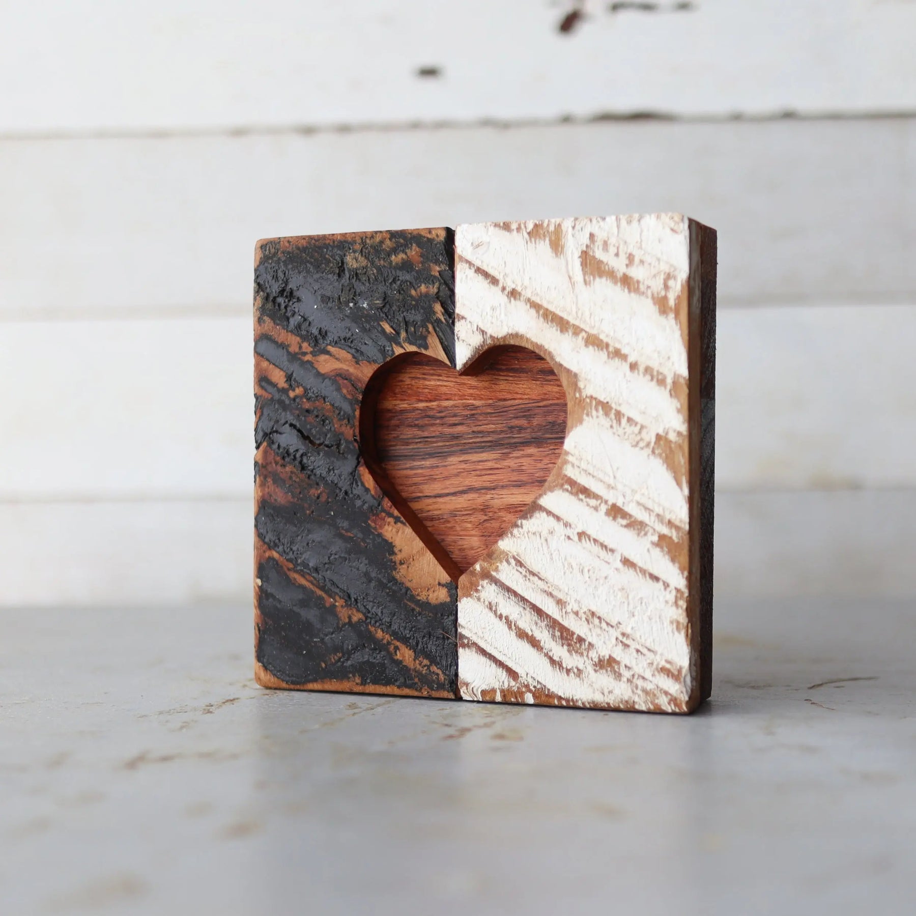 Two-tone rustic wooden heart cutout decor with distinct rough and smooth textures.