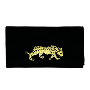 Black clutch with gold leopard design and black spots.