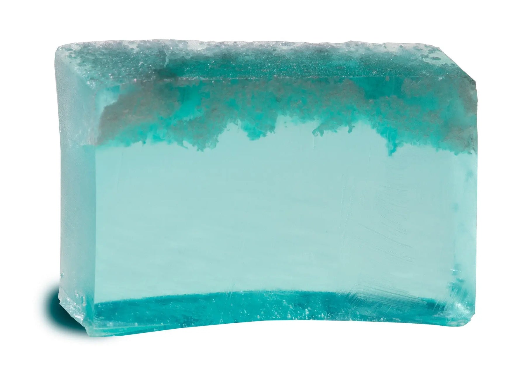 Translucent turquoise sea salt soap slice with visible salt crystals and a soft gradient effect.