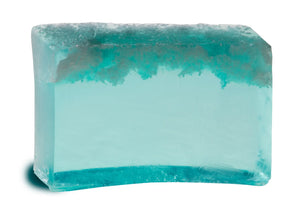 Translucent turquoise sea salt soap slice with visible salt crystals and a soft gradient effect.