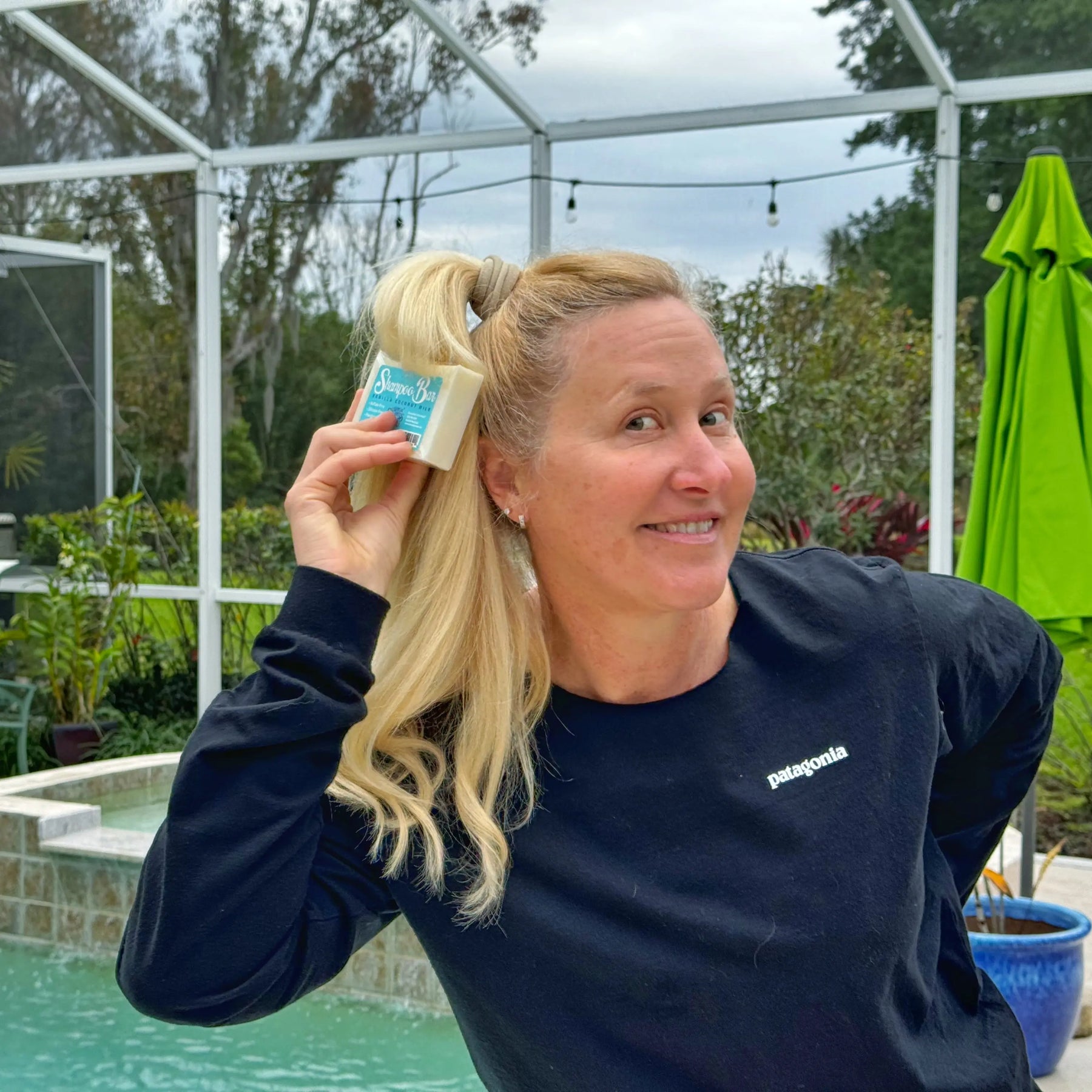 Woman holding a 5 oz Vanilla Coconut Milk Shampoo Bar from Essential Journeys.