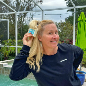 Woman holding a 5 oz Vanilla Coconut Milk Shampoo Bar from Essential Journeys.